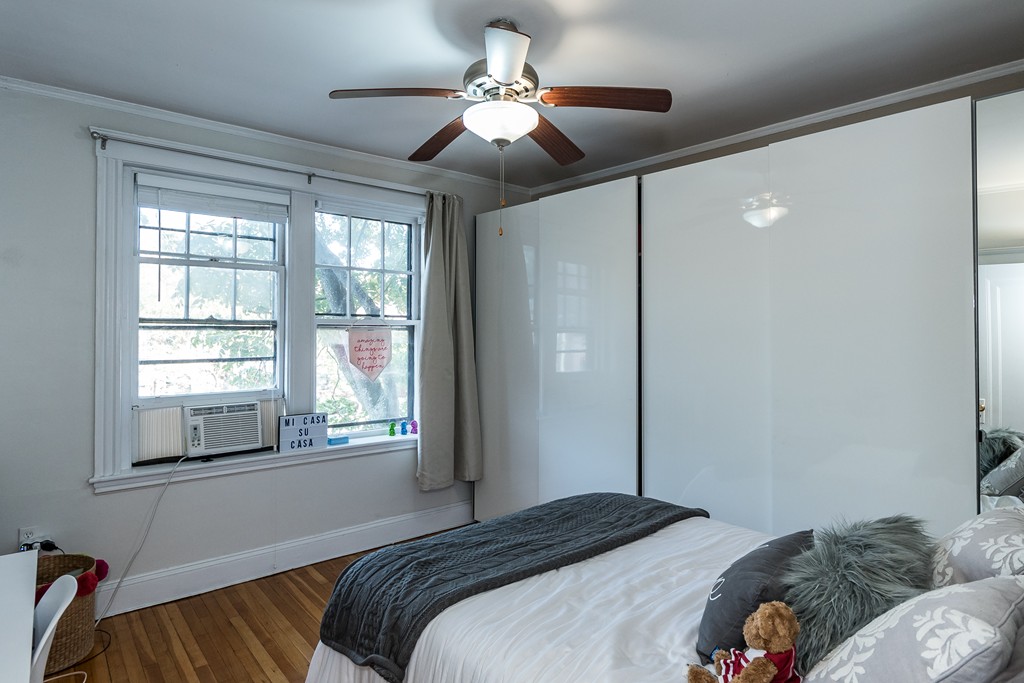 1982 Commonwealth Avenue, Unit 4 Boston, MA 02135 - Photo 10 of 17 a bedroom with a bed and a chandelier