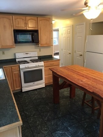 704 Valley Road Barre, MA 01005 - Photo 6 of 19 a kitchen with a wooden floor and a stove top oven