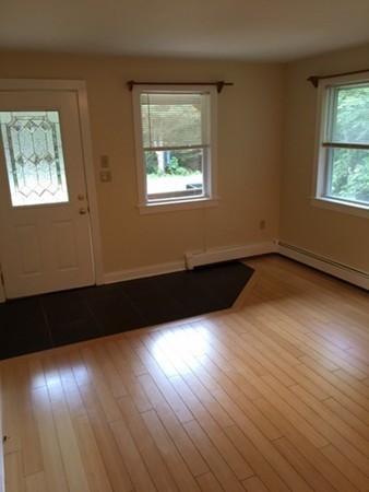 704 Valley Road Barre, MA 01005 - Photo 9 of 19 a view of an empty room hardwood floor and windows