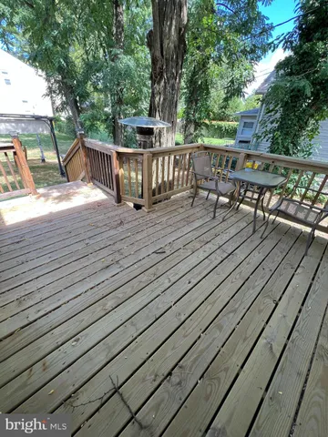 a view of a deck with wooden floor and outdoor seating