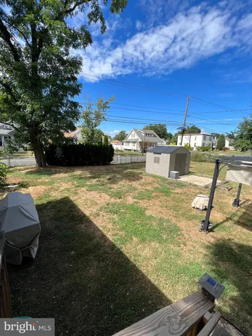 a view of a swimming pool with an outdoor seating and a yard