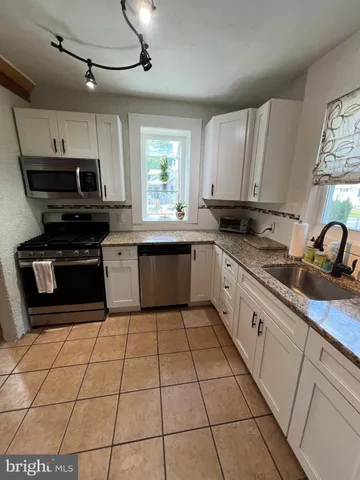 a kitchen with stainless steel appliances cabinets a sink and a stove