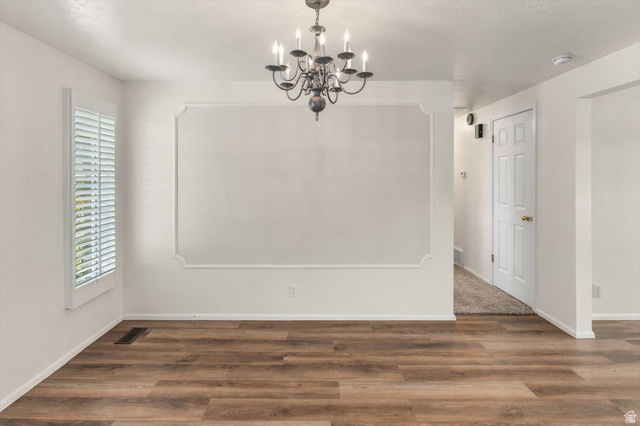 15295 North 5400th Street West Riverside, UT 84334 - Photo 17 of 54 Wood-finish flooring throughout, complemented by a decorative wall molding accent