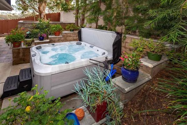 a view of a backyard with chair and potted plants