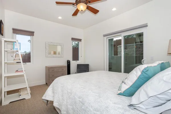 a bedroom with a bed cabinets and window