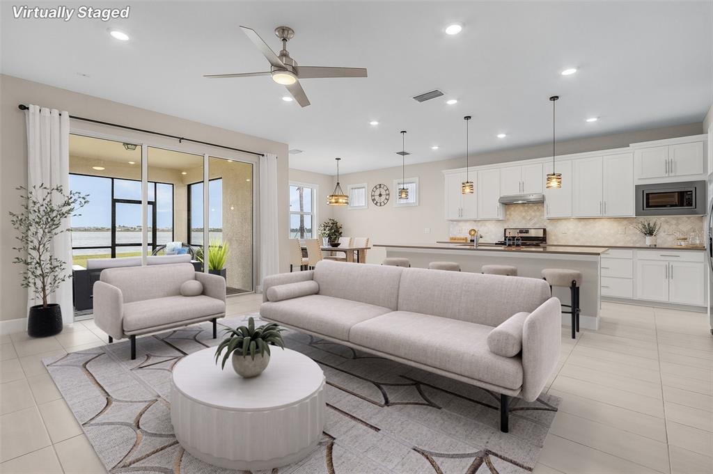 a living room with furniture kitchen view and a large window