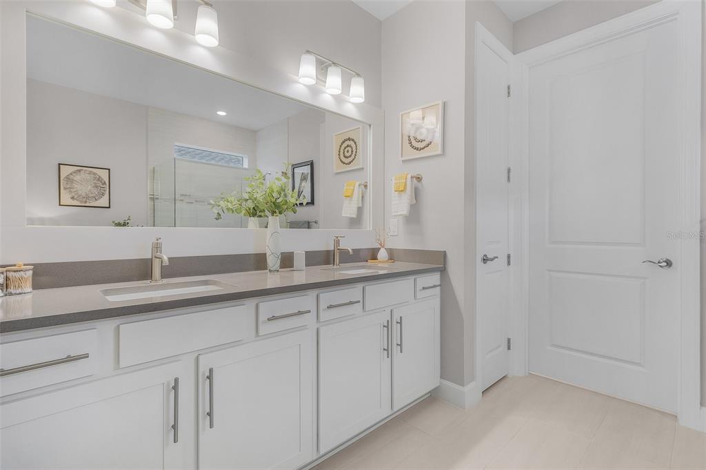 42211 Edgewater Drive Punta Gorda, FL 33982 - Photo 12 of 36 a spacious bathroom with a granite countertop sink and a mirror