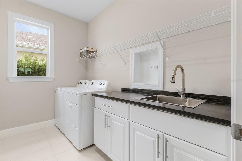 42211 Edgewater Drive Punta Gorda, FL 33982 - Photo 17 of 36 a close view of a sink a faucet and a dishwasher in a kitchen
