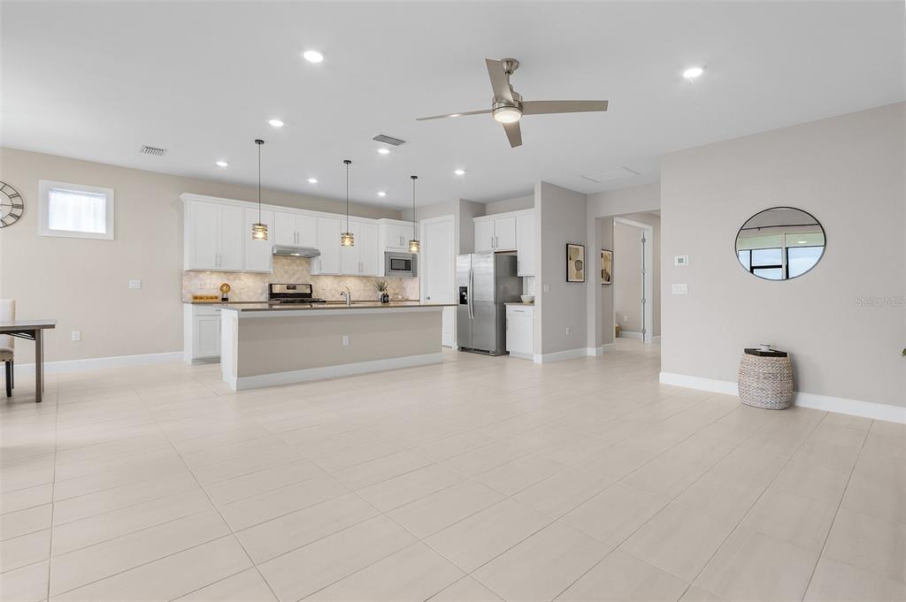 42211 Edgewater Drive Punta Gorda, FL 33982 - Photo 5 of 36 a kitchen with stainless steel appliances kitchen island a refrigerator sink and cabinets