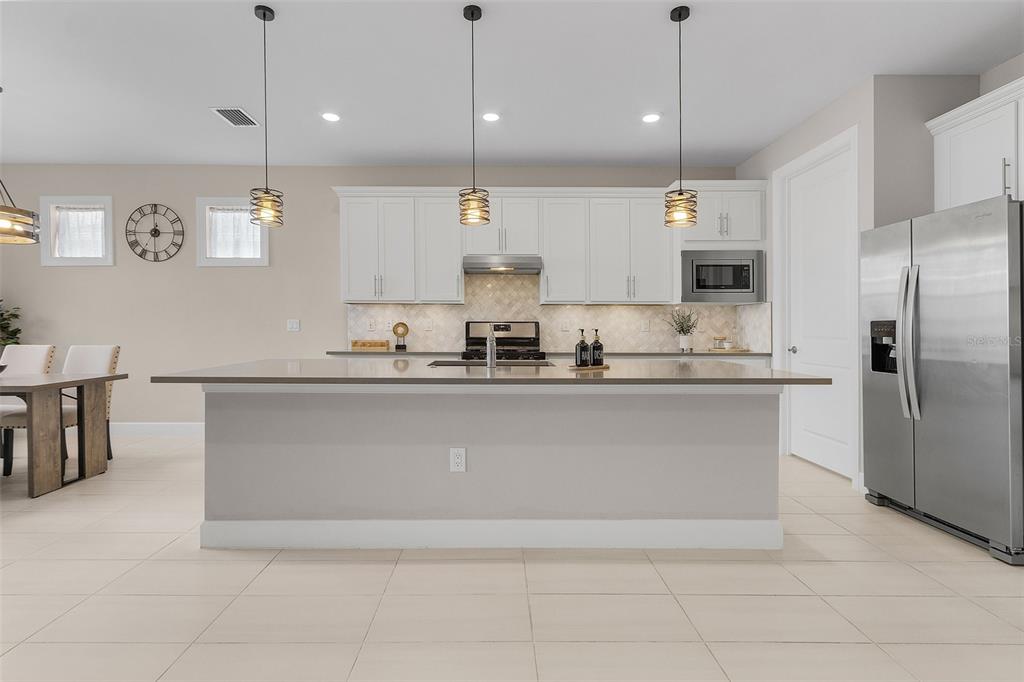 42211 Edgewater Drive Punta Gorda, FL 33982 - Photo 6 of 36 a kitchen with kitchen island stainless steel appliances a sink a stove a refrigerator and cabinets
