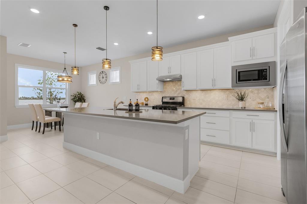 42211 Edgewater Drive Punta Gorda, FL 33982 - Photo 7 of 36 a kitchen with kitchen island granite countertop a sink a counter top space appliances and cabinets