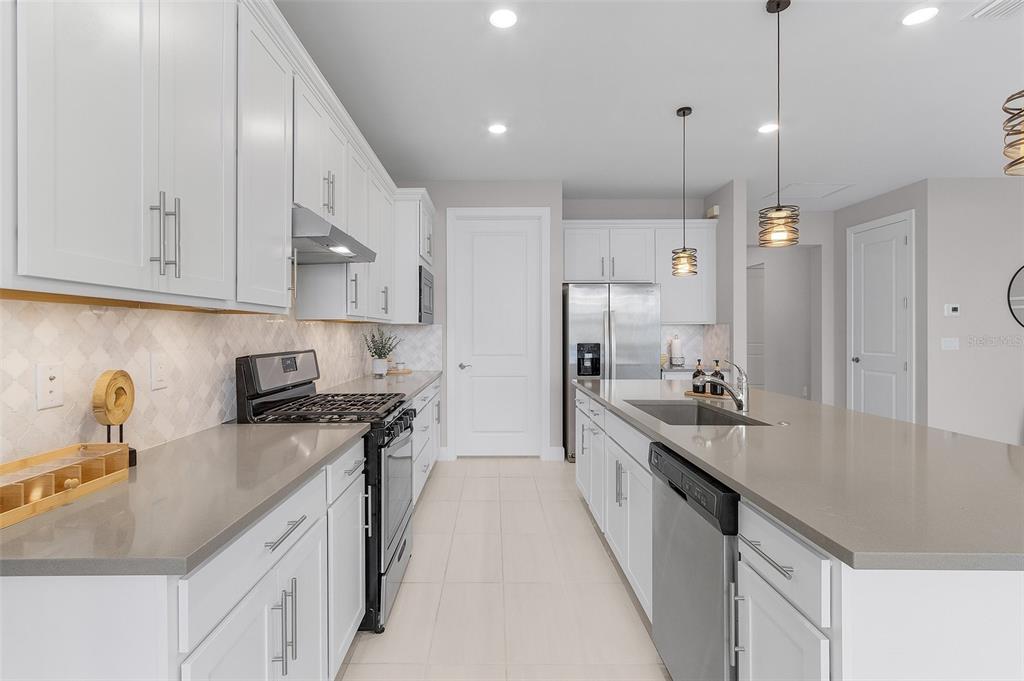 42211 Edgewater Drive Punta Gorda, FL 33982 - Photo 8 of 36 a kitchen with stainless steel appliances granite countertop a sink stove and refrigerator