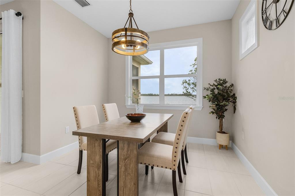 42211 Edgewater Drive Punta Gorda, FL 33982 - Photo 9 of 36 a view of a dining room with furniture window and wooden floor