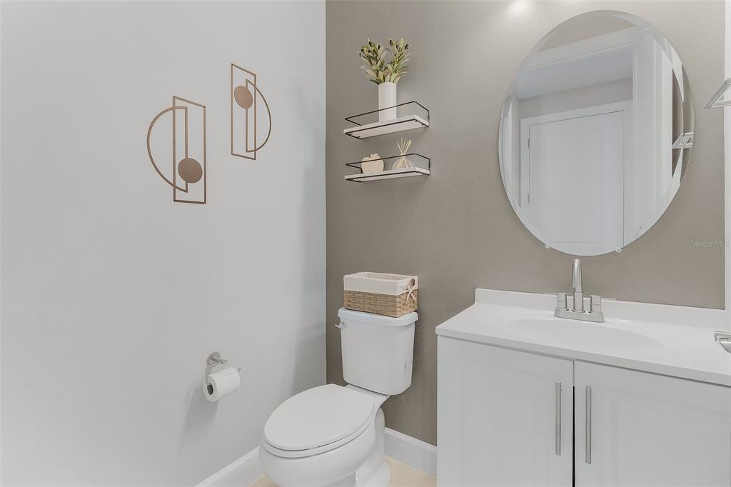 42211 Edgewater Drive Punta Gorda, FL 33982 - Photo 10 of 36 a bathroom with a toilet a sink and mirror