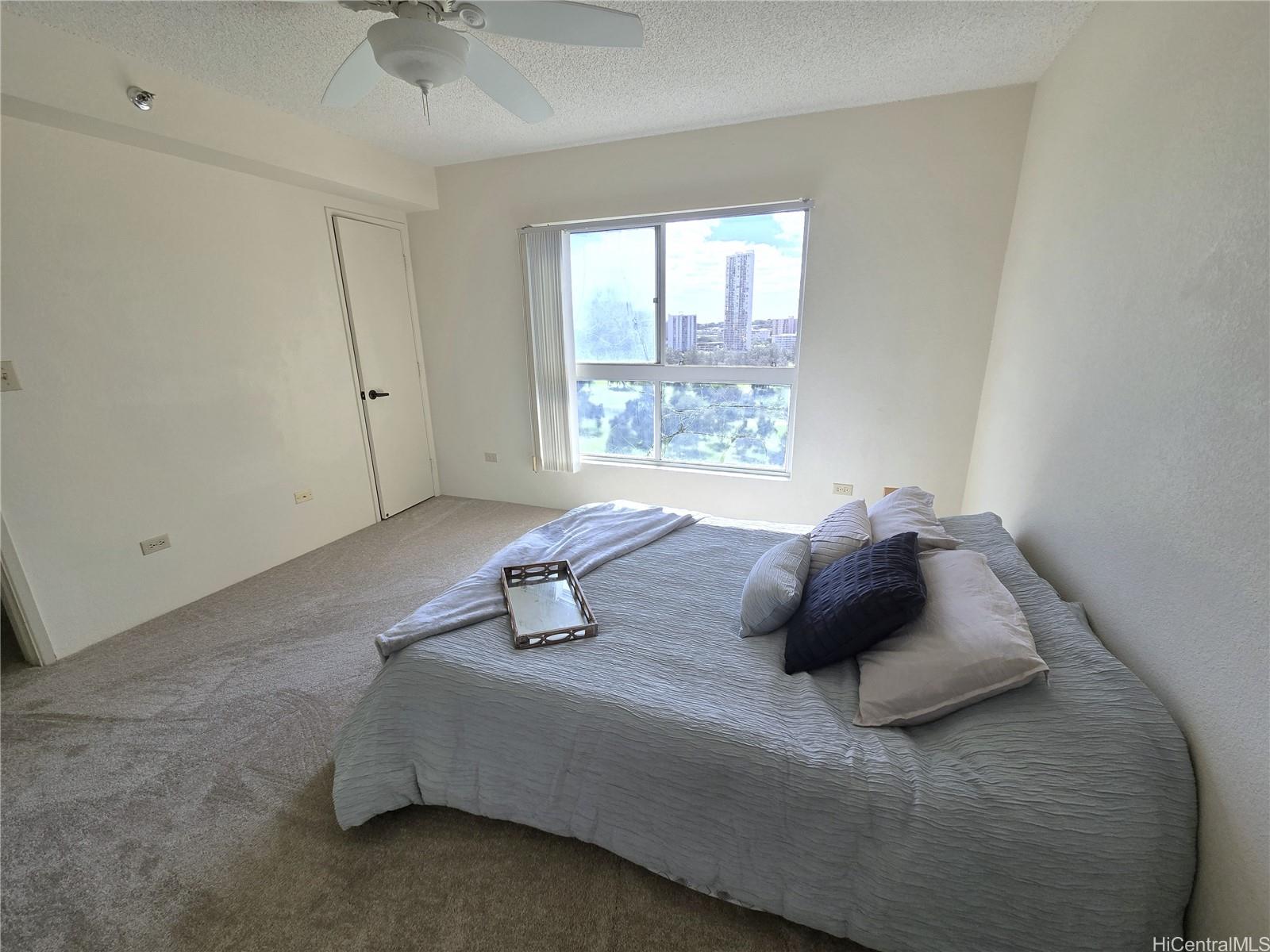 3075 Ala Poha Place, Unit 1504 Honolulu, HI 96818 - Photo 11 of 22 a bedroom with a bed and a window