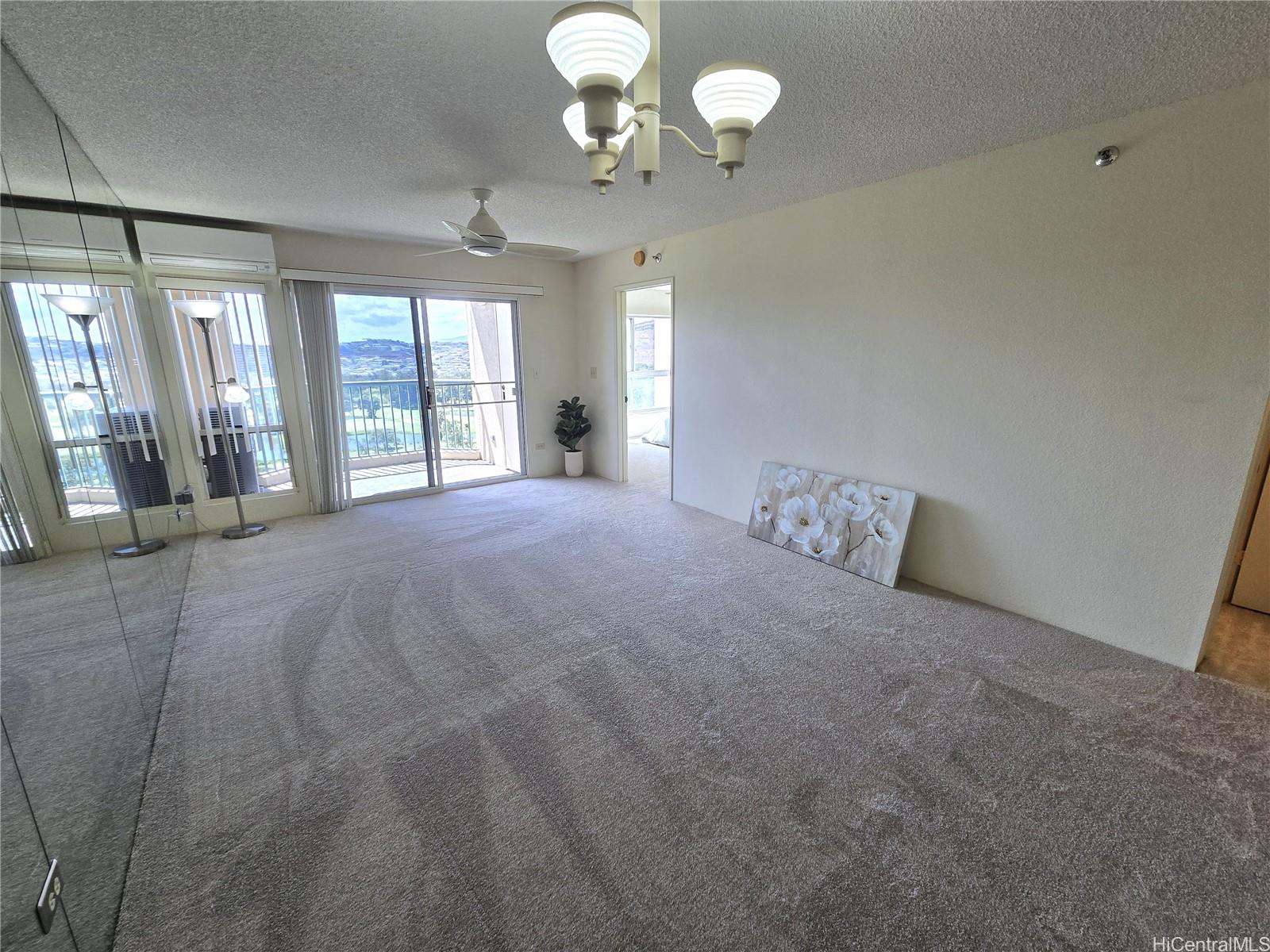 3075 Ala Poha Place, Unit 1504 Honolulu, HI 96818 - Photo 12 of 22 a large bed sitting in a bedroom next to a large window