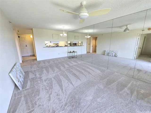 a view of a kitchen with a sink and a refrigerator