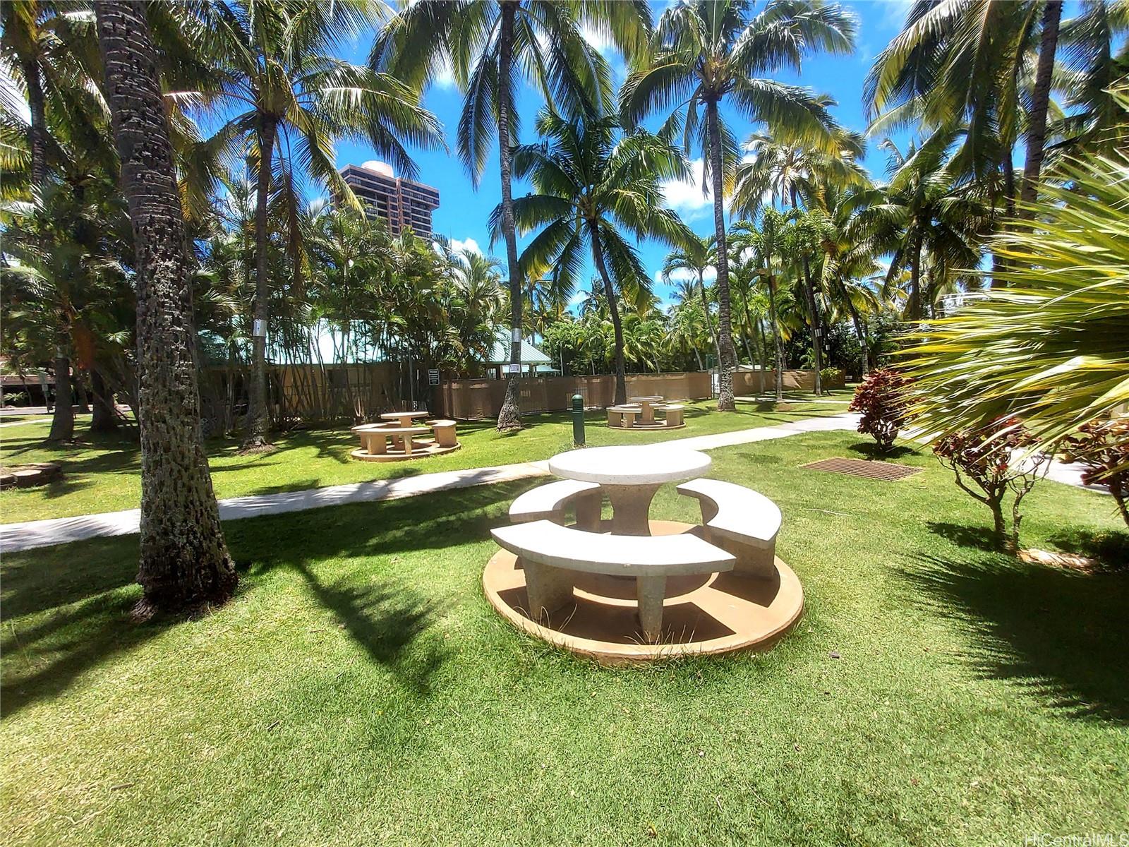 3075 Ala Poha Place, Unit 1504 Honolulu, HI 96818 - Photo 21 of 22 a view of a swimming pool with a yard