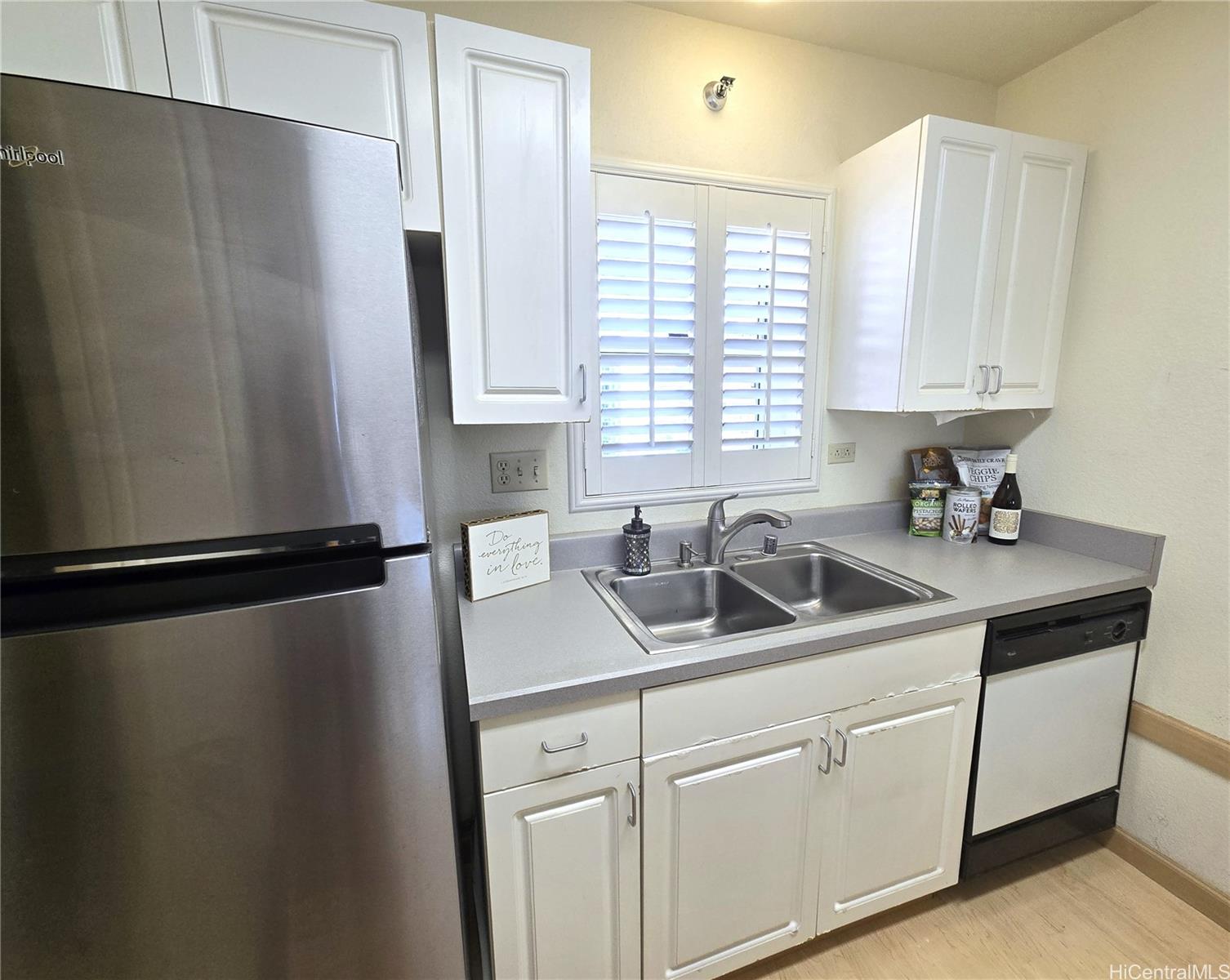 3075 Ala Poha Place, Unit 1504 Honolulu, HI 96818 - Photo 3 of 22 a kitchen with a refrigerator and a sink