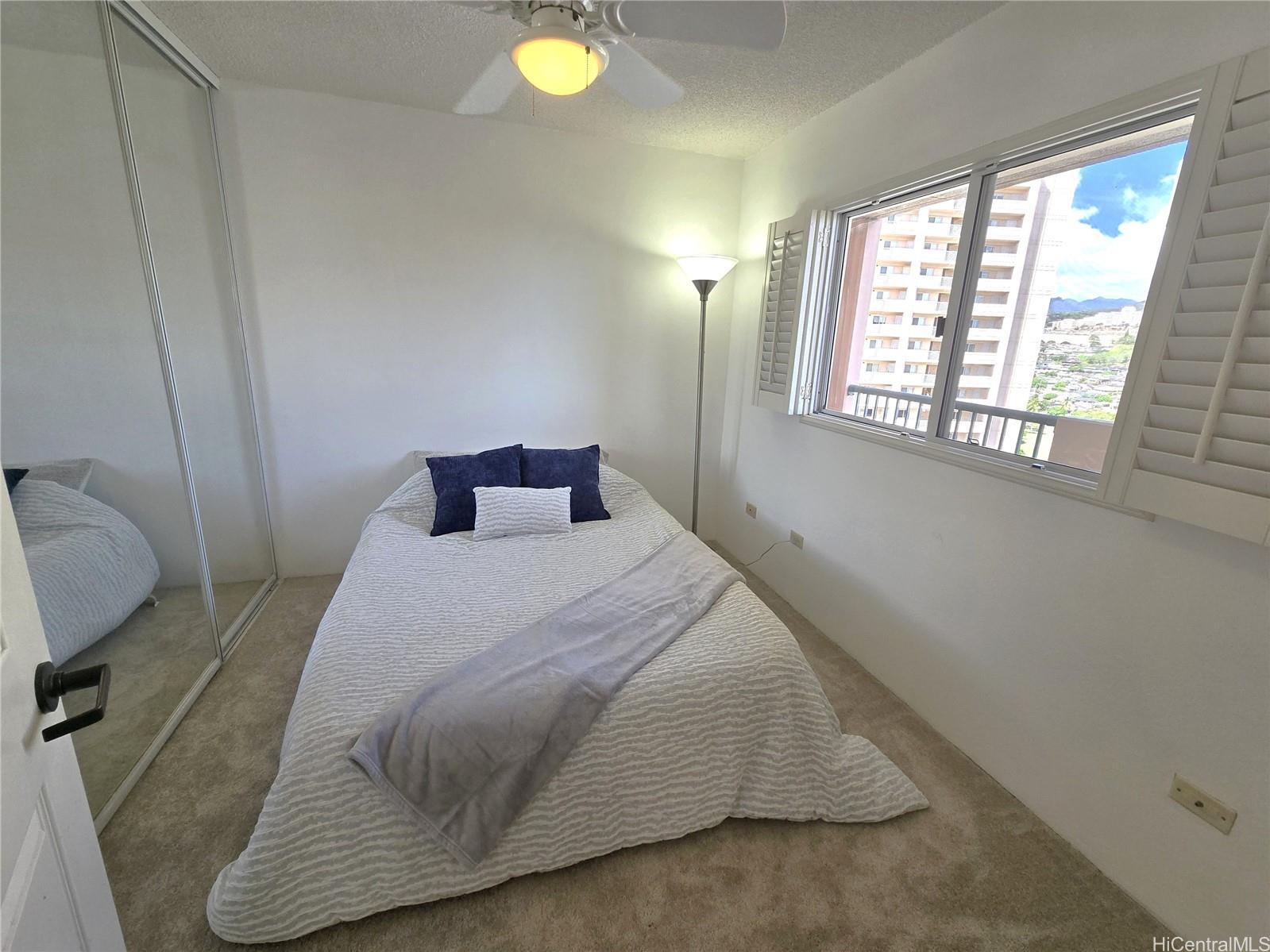 3075 Ala Poha Place, Unit 1504 Honolulu, HI 96818 - Photo 5 of 22 a bedroom with a bed and window