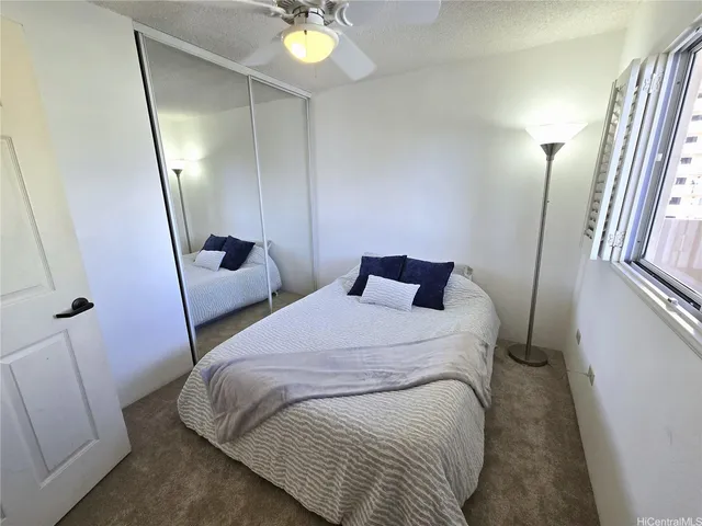 a bedroom with a bed and a lamp