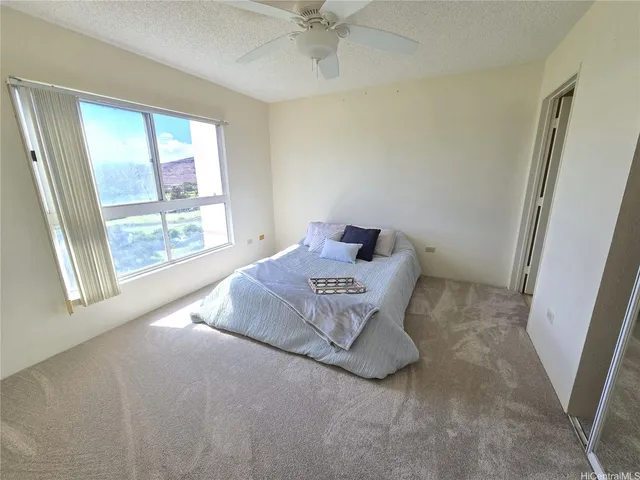 a spacious bedroom with a bed and a window