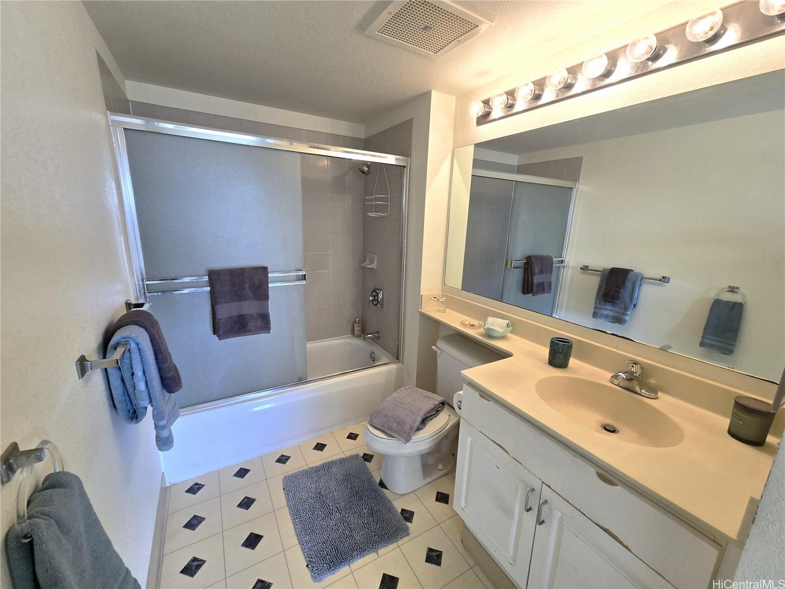 3075 Ala Poha Place, Unit 1504 Honolulu, HI 96818 - Photo 10 of 22 a bathroom with a bathtub shower sink vanity and toilet