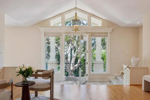a living room with furniture large window and fireplace