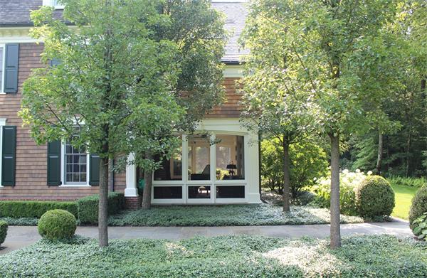 174 Highland Street Weston, MA 02493 - Photo 11 of 29 a front view of a house with a garden