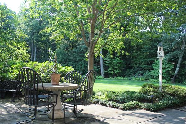 174 Highland Street Weston, MA 02493 - Photo 13 of 29 a wooden bench with some trees