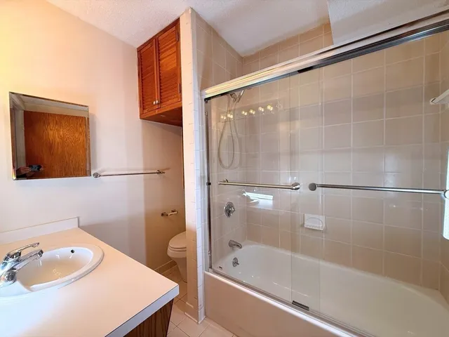 a bathroom with a tub and shower