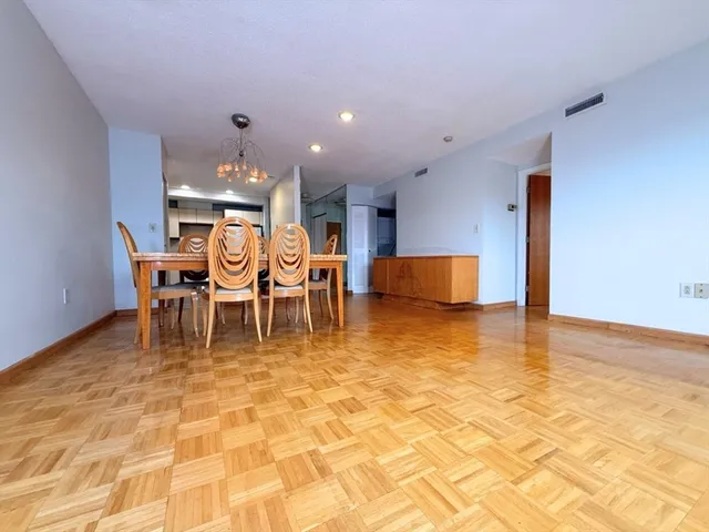 a dining room with furniture and a view of kitchen