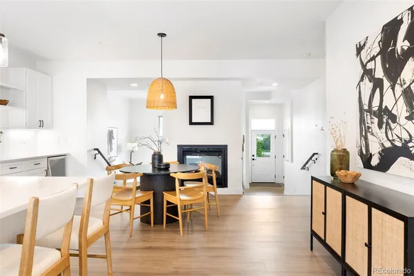 a kitchen with wooden floors and white cabinets