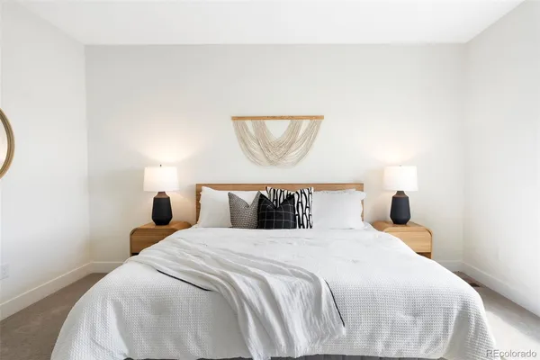 a bed sitting in a bedroom next to a window