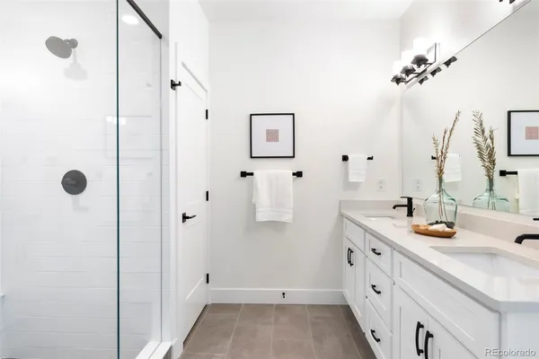 a bathroom with a shower and a plant