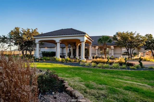 a view of a house with garden and sitting area