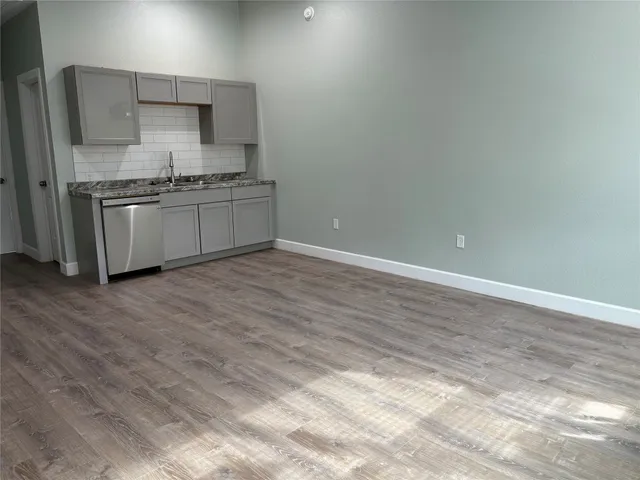 a kitchen with stainless steel appliances a sink stove and cabinets