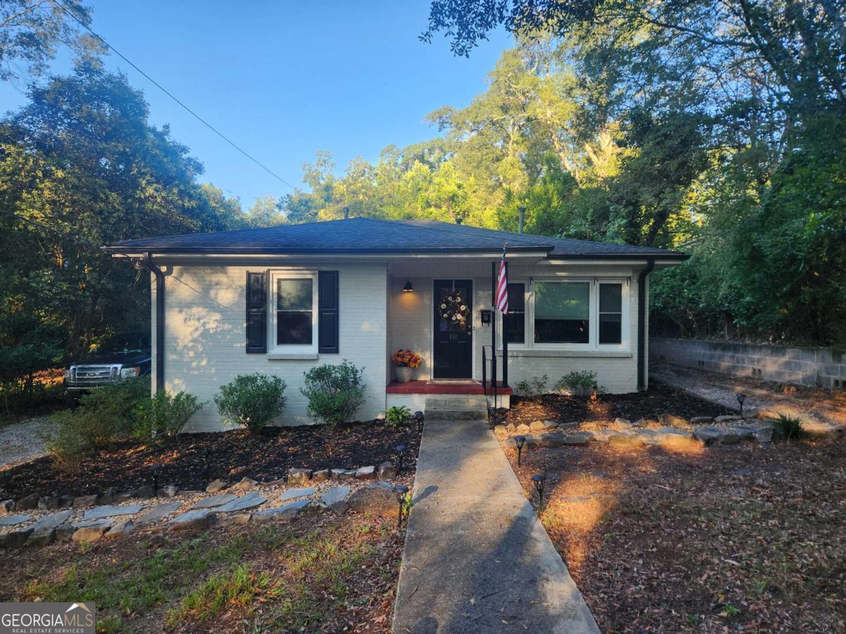 a front view of a house with a garden