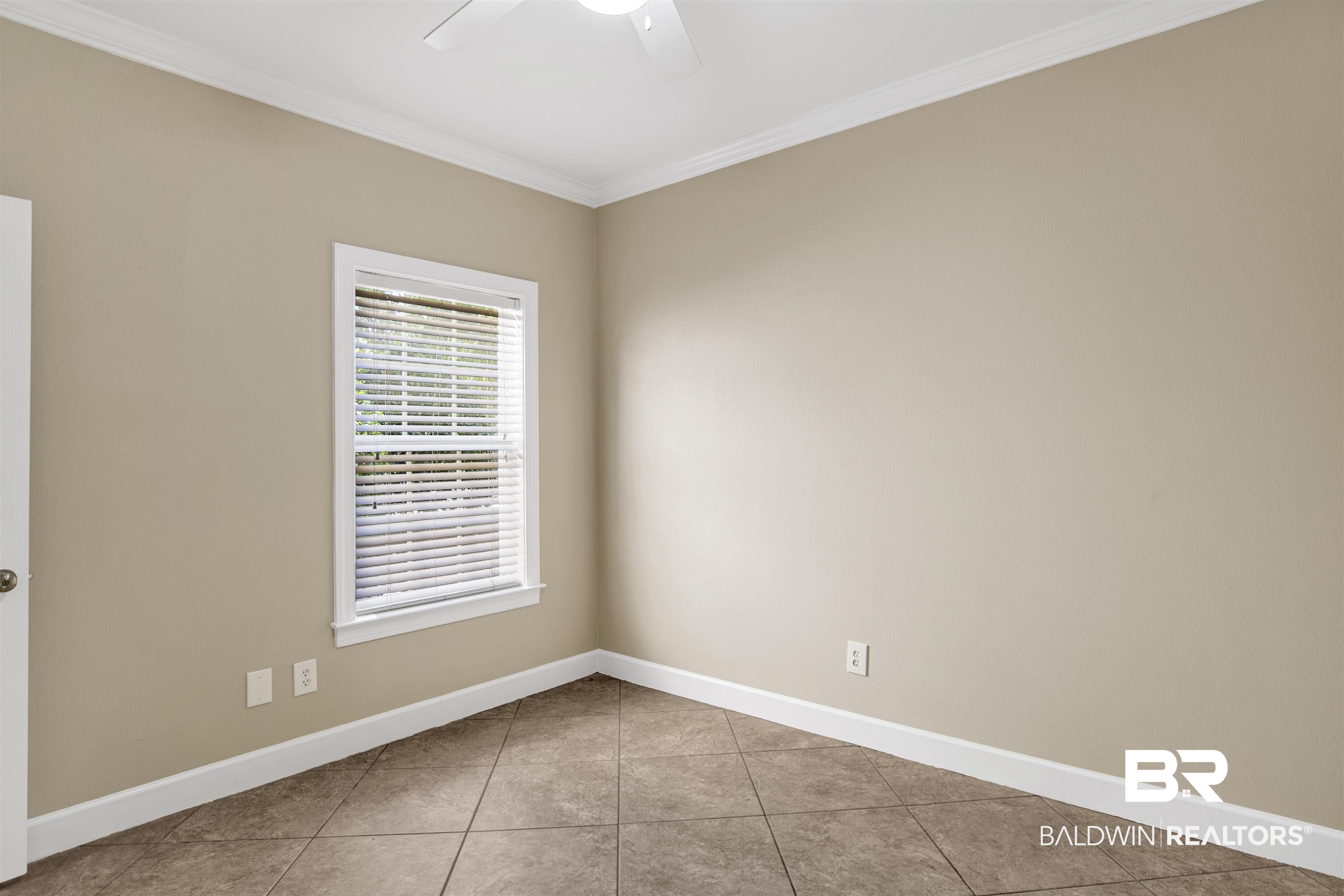 450 Park Avenue, Unit 202 Foley, AL 36535 - Photo 11 of 18 Empty room with ornamental molding and light tile patterned flooring