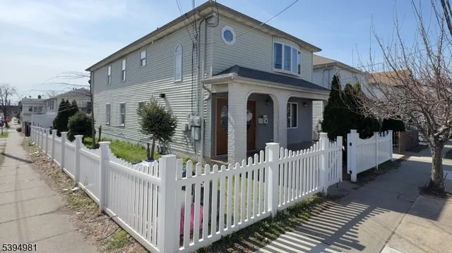 a view of a house with wooden fence