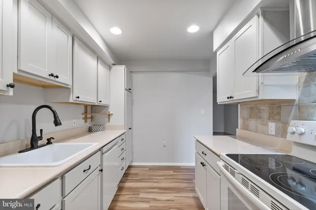 a kitchen with stainless steel appliances granite countertop a sink and cabinets