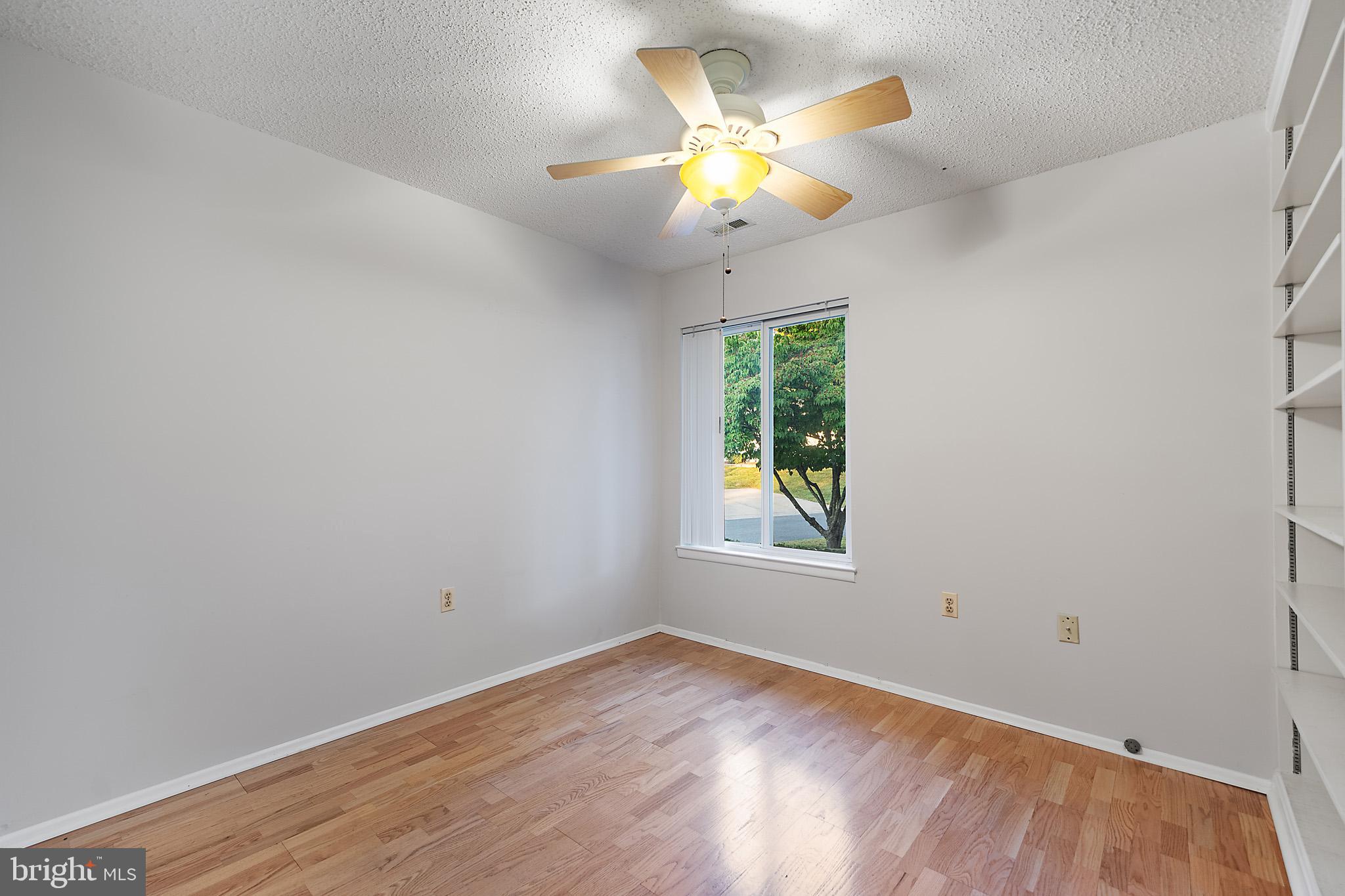 2 Finsbury Park Court, Unit 47A Silver Spring, MD 20906 - Photo 20 of 24 an empty room with a chandelier fan and wooden floor