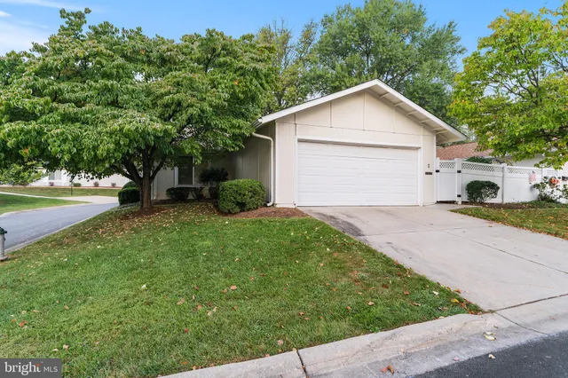 a view of a house with a yard and garage