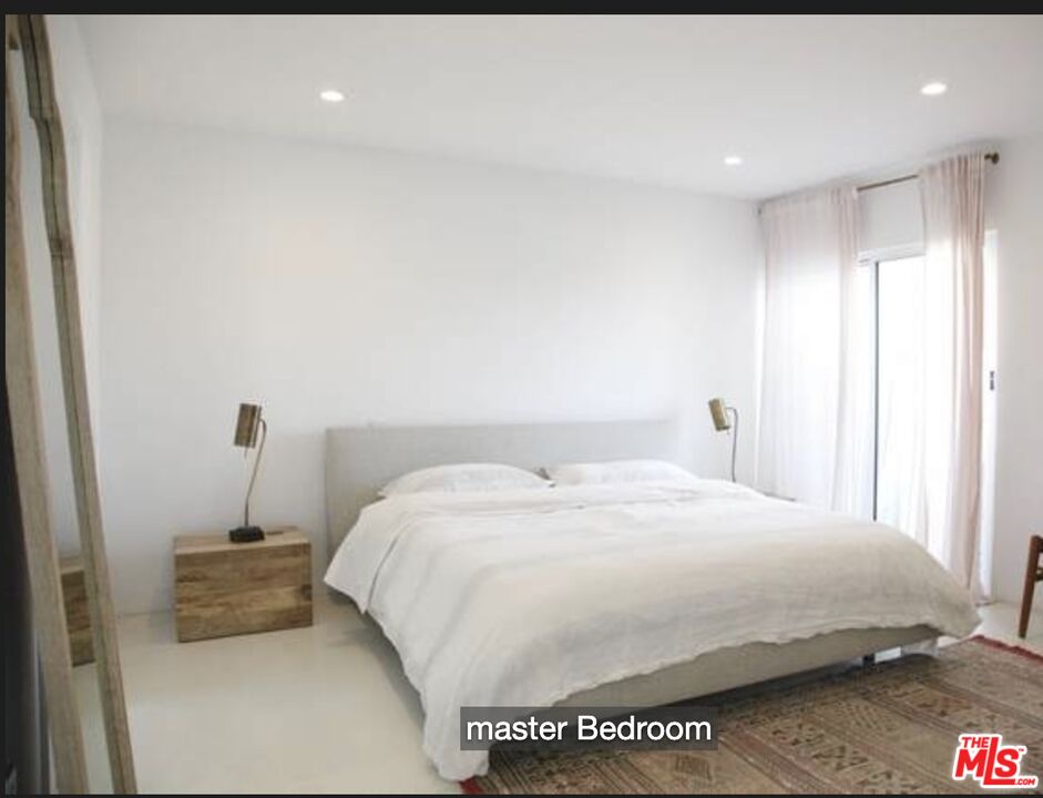 3817 Surfwood Road Malibu, CA 90265 - Photo 12 of 26 a bedroom with a bed and a window