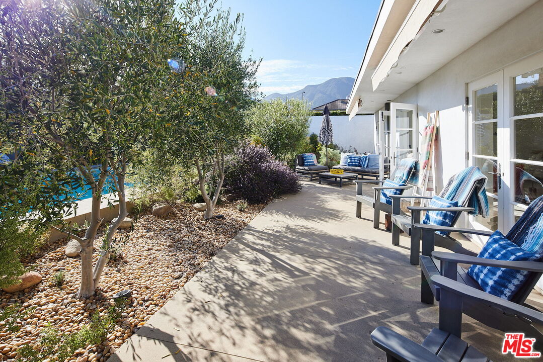3817 Surfwood Road Malibu, CA 90265 - Photo 17 of 26 a view of a patio with chairs and potted plants