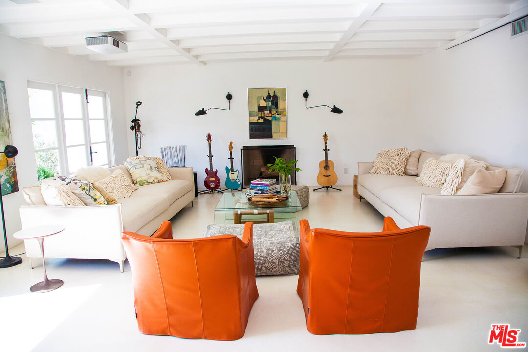 3817 Surfwood Road Malibu, CA 90265 - Photo 2 of 26 a living room with furniture and a fireplace