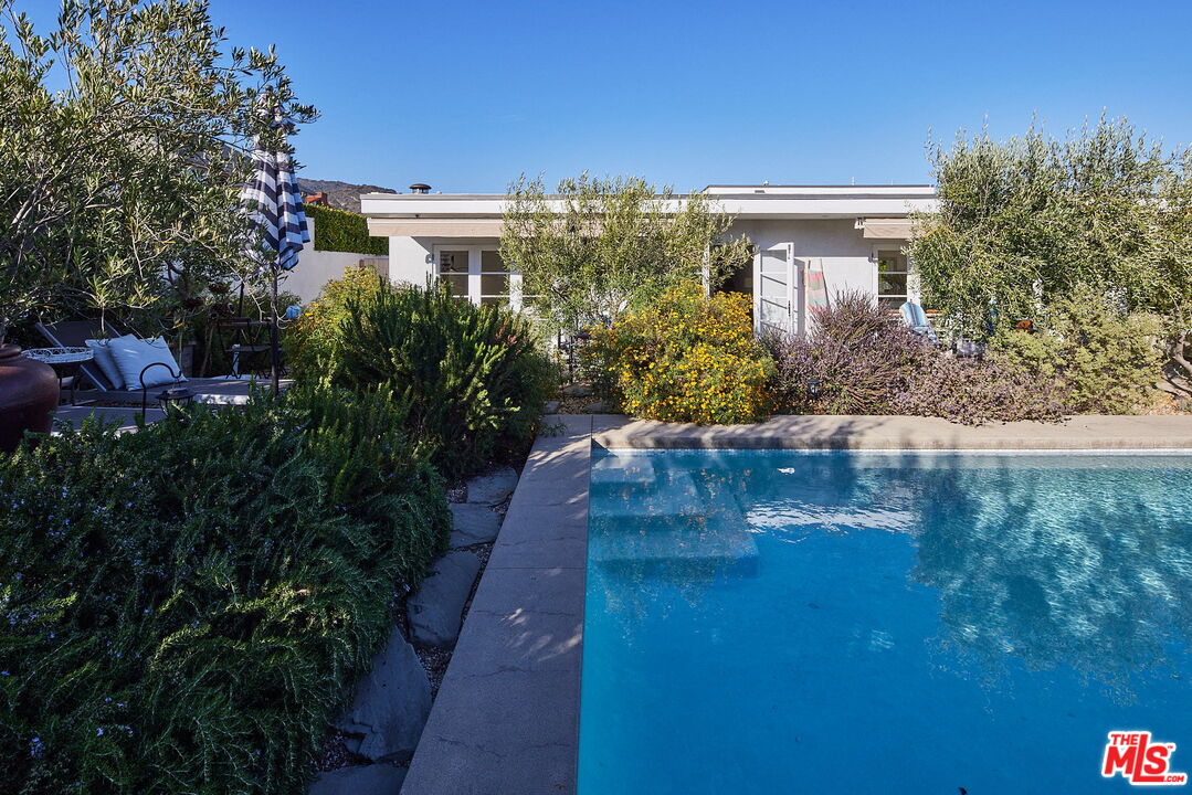 3817 Surfwood Road Malibu, CA 90265 - Photo 22 of 26 a view of a house with a yard