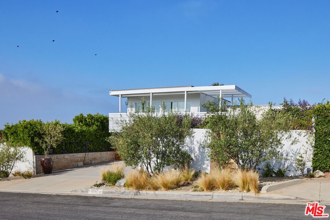 3817 Surfwood Road Malibu, CA 90265 - Photo 25 of 26 a front view of a house with a yard
