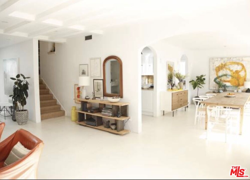 3817 Surfwood Road Malibu, CA 90265 - Photo 7 of 26 a living room with furniture a flat screen tv and a table