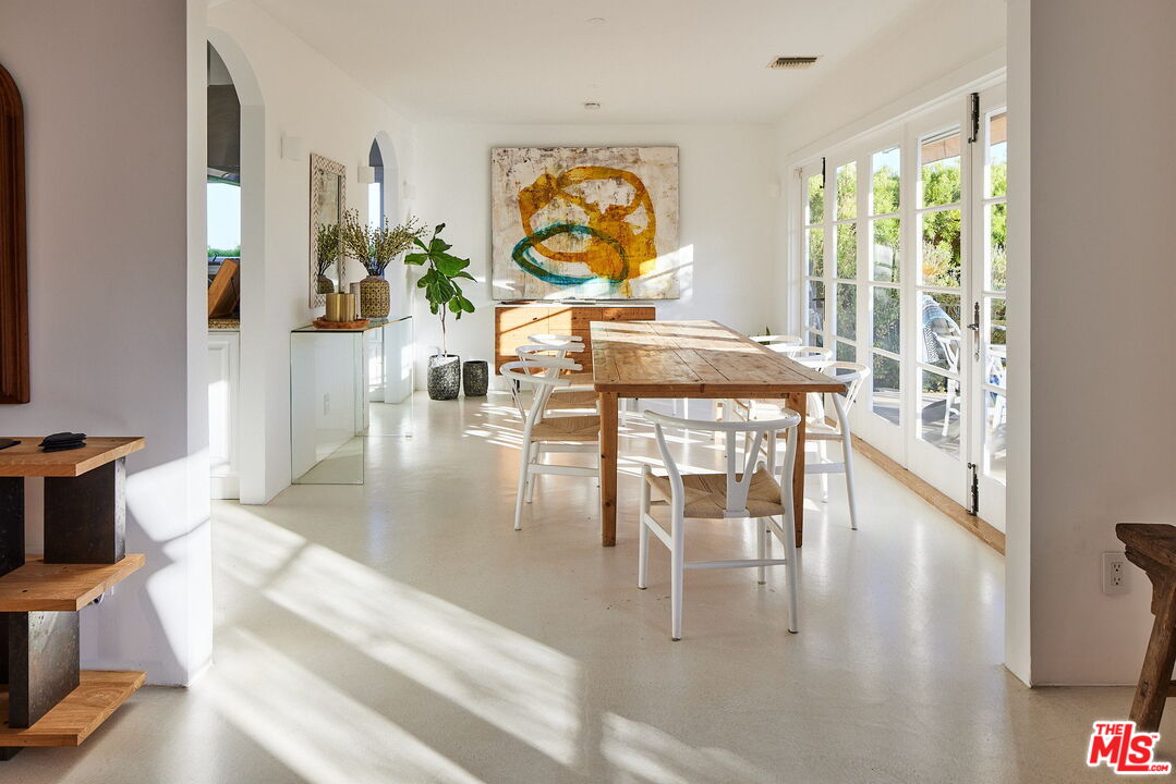 3817 Surfwood Road Malibu, CA 90265 - Photo 9 of 26 a living room with fireplace furniture and a large window